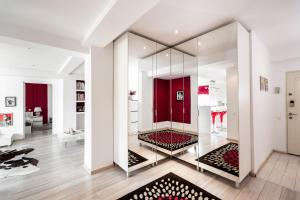 a living room with a mirror and a red door at Qult - Old City Pearl in Bucharest