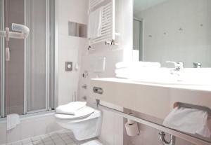 un bagno bianco con un water e un lavandino di Inselresidenz Strandburg Juist FeW a Juist