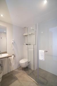 
a bathroom with a toilet a sink and a shower at Hotel Abelay in Palma de Mallorca
