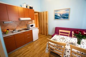 a small kitchen with a table and a dining room at Alo Apartments Vila Klara in Ljubljana