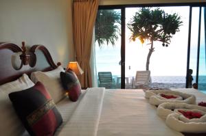 a bedroom with a bed with a view of the ocean at Lanta Seafront Resort in Ko Lanta