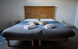 a bedroom with a bed with two pillows on it at La Controra Hostel Naples in Naples