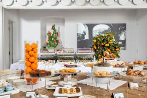 a buffet with oranges and other food on tables at Hotel Punta Tragara in Capri