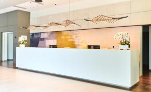 an office lobby with a white reception desk at Apartments Park Plava Laguna in Poreč +32 photos