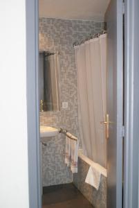 a bathroom with a shower curtain and a sink at Anaco in Madrid