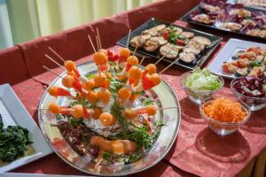 a table with a plate of food on a table at Hotel Bologna in Misano Adriatico