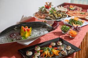 een tafel met meerdere borden voedsel erop bij Hotel Bologna in Misano Adriatico