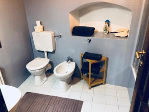 a small bathroom with a toilet and a sink at Al Belenzani Appartamento in Trento +16 photos