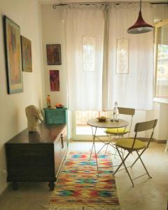 a living room with a table and a table and chairs at Amariglio Apartment in Sassari