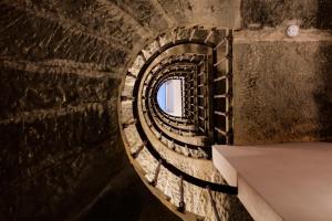 a spiral staircase in a building with a window at The Frame Hotel in Florence
