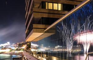 a rendering of a building at night with fireworks at Hotel Excelsior in Dubrovnik