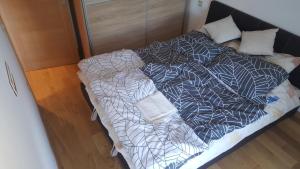 an unmade bed in a small room with at Apartman Mir in Zlatibor