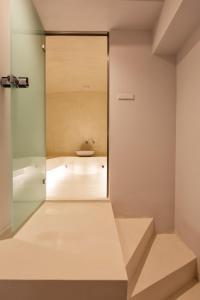 a bathroom with a mirror and a tub at Erato by Samian Mare in Karlovasi