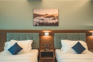 Postel nebo postele na pokoji v ubytování Henia Hotel