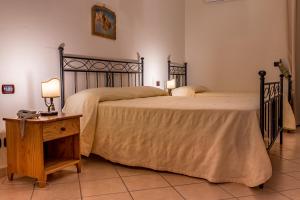 En eller flere senger på et rom på Tenuta Sciacca