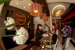 a group of people standing around a table in a store at Pacific Suites Hotel in Tacna