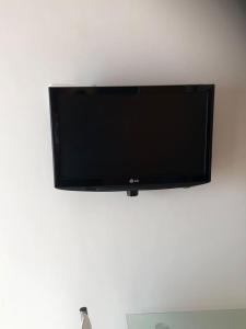 a flat screen tv hanging on a wall at Cà Suma in Borgio Verezzi