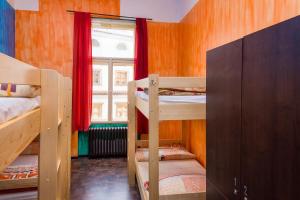 
a small room with a bed and a window at Best Spot Hostel in Prague
