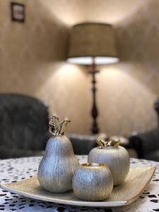 two silver pumpkins sitting on a plate on a table at Apartment on Franka in Lviv
