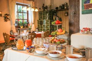 a table with plates of food and fruit on it at Pension zur Weinlaube in Bornheim