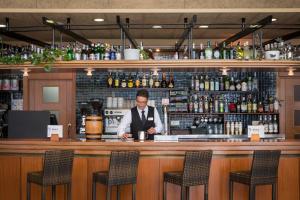 a man sitting at a bar in a pub at htop Platja Park - Bliss in Platja d'Aro +26 photos