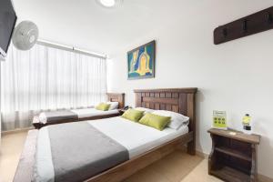 Postel nebo postele na pokoji v ubytování Ayenda 1120 Hotel Comercial