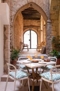 a table with two chairs and a table with food on it at Ramón Llull House in Palma de Mallorca