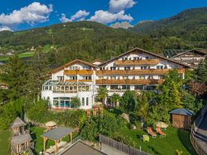 an aerial view of a hotel with mountains in the background at Family Hotel Gutenberg in Schenna