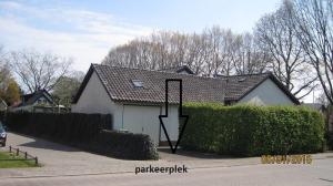 a house with a garage in a driveway at B&B Bosrand in Groesbeek