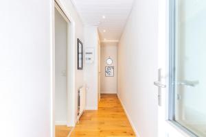 a hallway with white walls and a wooden floor at Bronx in the Centre of Tórshavn in Tórshavn
