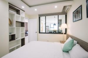 Giường trong phòng chung tại Da Nang Daisy Apartment
