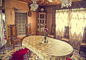 a large room with a table with flowers on it at Chicago Group of Houseboats in Srinagar