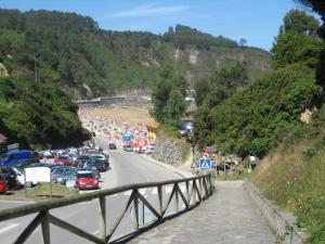 a crowd of cars parked on the side of a road at Casa Güelo in Muros de Nalón