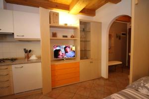 uma cozinha com uma televisão num balcão num quarto em Home White em Laives