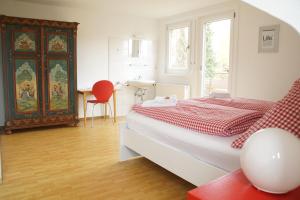 a bedroom with a bed and a table and a chair at Black Forest Lodge in Freudenstadt