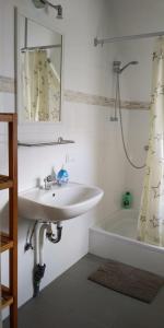 a bathroom with a sink and a mirror and a tub at Old town center apartments on the Romantic Road in Harburg
