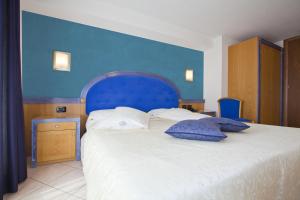 Posteľ alebo postele v izbe v ubytovaní Hotel Ambra
