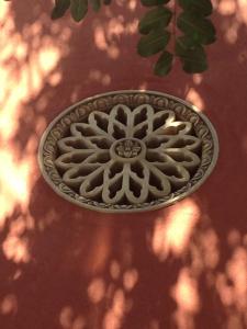 a metal drain on a red wall with a tree branch at Villa Astoria in Taormina
