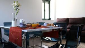 a living room with a table and a couch at Apartamentos AUGA in Fene +17 photos