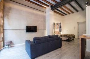 a living room with a couch and a tv at Beautiful loft in old town in Alicante