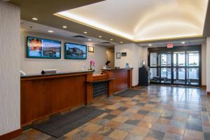 a lobby of a hotel with a reception desk at Service Plus Inns and Suites Calgary in Calgary