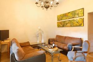 a living room with two couches and a table at Chateau de Montfroc in Montfroc