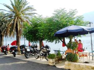 a group of motorcycles parked next to the water at Pana-Eustahije 253 in Kotor