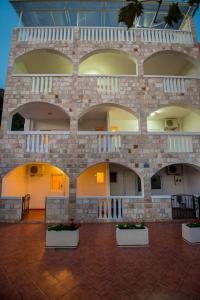 a large brick building with two balconies on it at Vila Vukotić in Petrovac na Moru