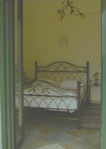 a bedroom with a bed with white sheets at Villa Platanaki in Kerveli