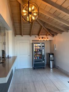 a kitchen with a refrigerator and a ceiling with a light at Morada Inn in Anaheim