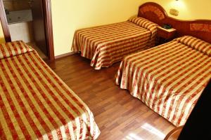 En eller flere senge i et værelse på Hotel Valdaso