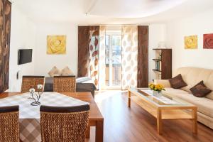 a living room with a couch and a table at Apartments Radstadt in Radstadt