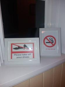 two signs sitting on a shelf in a room at Saudafell Guesthouse in Sauðafell