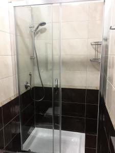 a shower with a glass door in a bathroom at Bakirooms in Rome